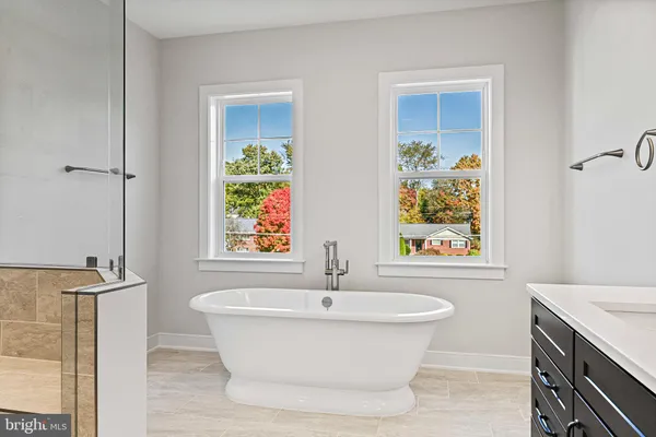 a white bath tub sitting next to a white sink