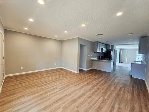 a kitchen with granite countertop kitchen island wooden cabinets and entryway