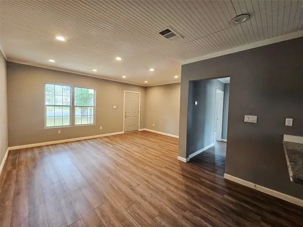 a kitchen with a sink window and cabinets