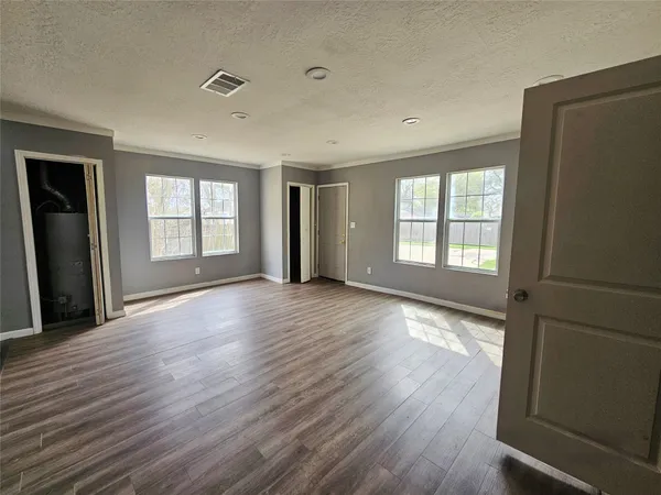 a kitchen with granite countertop kitchen island wooden floors appliances and cabinets