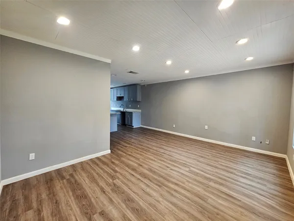 a kitchen with stainless steel appliances granite countertop white cabinets a refrigerator and a stove