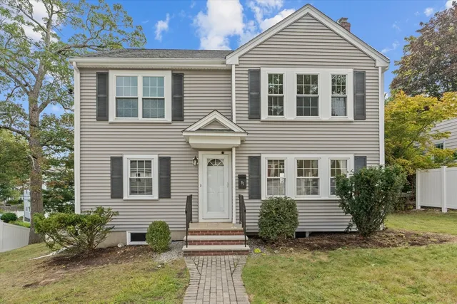 a front view of a house with a yard