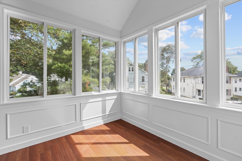 91 Prentice Street Waltham, MA 02451 - Photo 15 of 38 a view of an empty room with wooden floor and a window