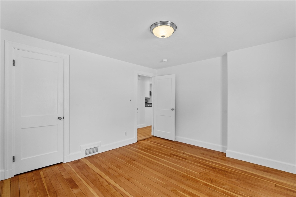 91 Prentice Street Waltham, MA 02451 - Photo 20 of 38 a view of empty room with wooden floor