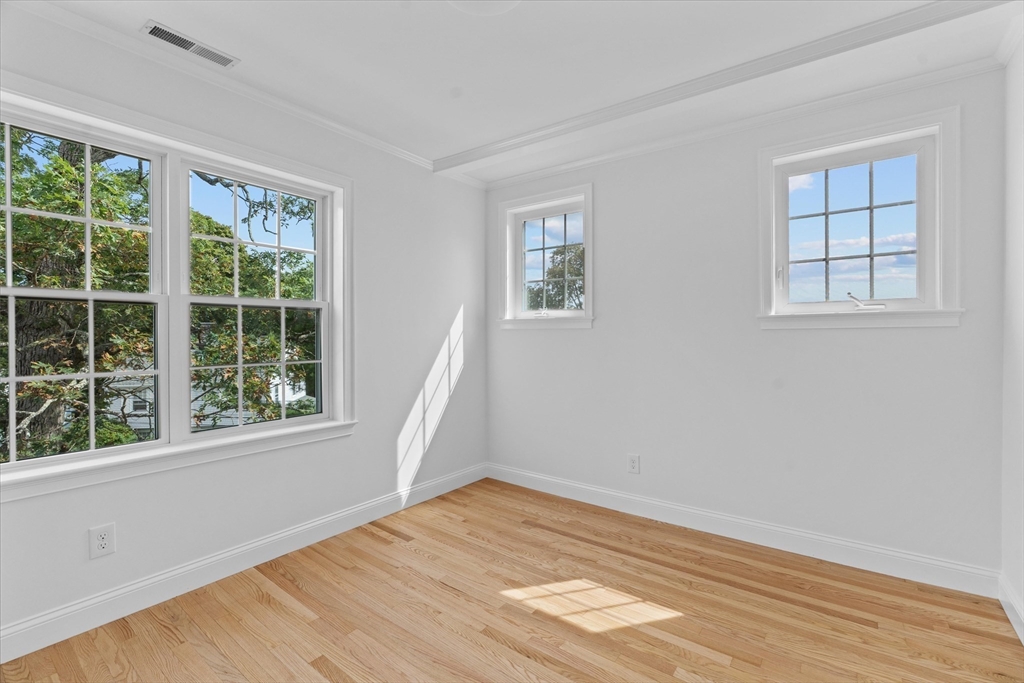 91 Prentice Street Waltham, MA 02451 - Photo 28 of 38 an empty room with wooden floor and windows