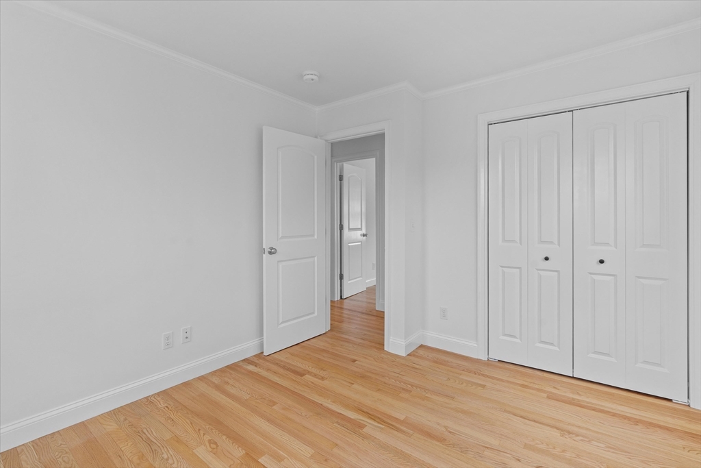91 Prentice Street Waltham, MA 02451 - Photo 29 of 38 a view of an empty room with wooden floor