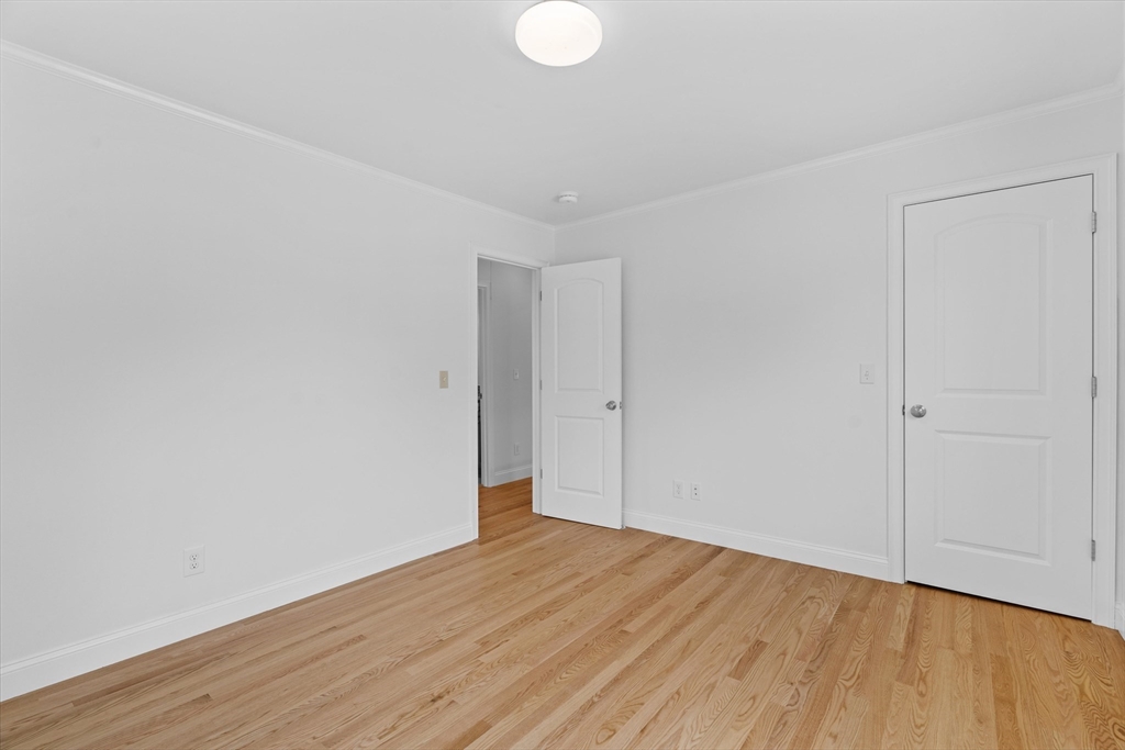 91 Prentice Street Waltham, MA 02451 - Photo 32 of 38 a view of an empty room with wooden floor