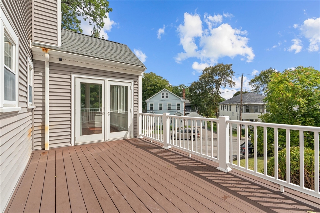 91 Prentice Street Waltham, MA 02451 - Photo 33 of 38 a view of a wooden deck with a yard