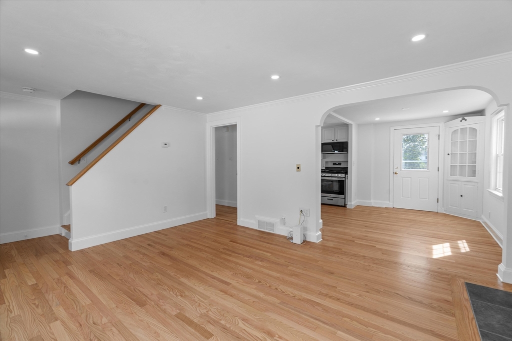 91 Prentice Street Waltham, MA 02451 - Photo 4 of 38 a view of empty room with wooden floor and window