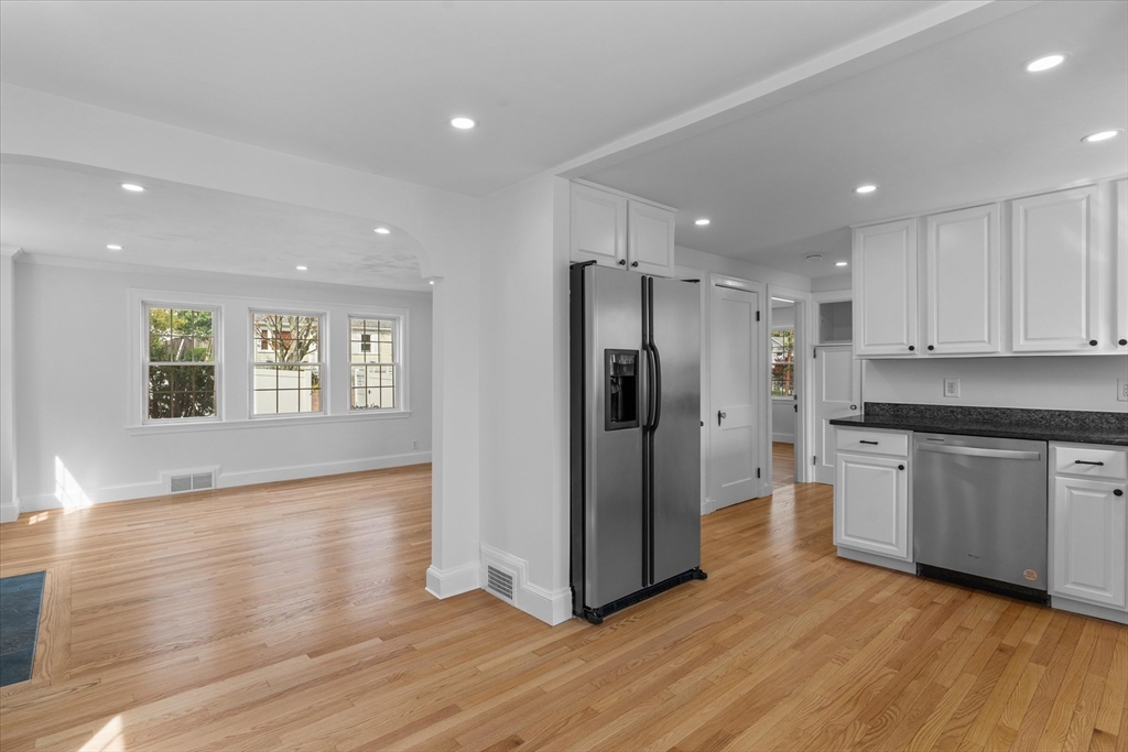 91 Prentice Street Waltham, MA 02451 - Photo 7 of 38 a kitchen with stainless steel appliances granite countertop a refrigerator and a stove top oven