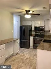 a kitchen with stainless steel appliances a refrigerator a stove a microwave and island