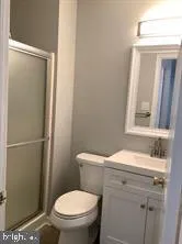 a bathroom with a toilet a sink and a mirror