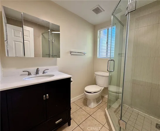 a bathroom with a sink toilet a mirror and shower
