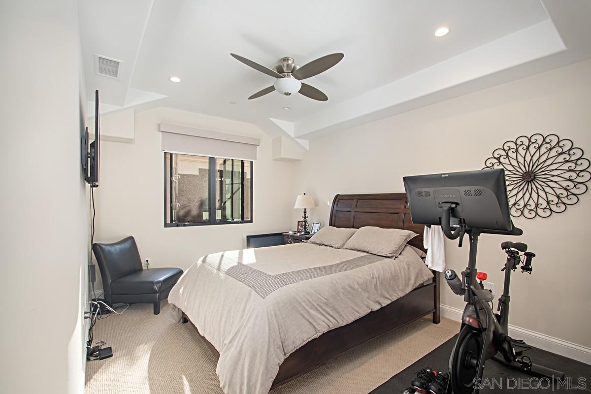 712 Silver Street La Jolla, CA 92037 - Photo 11 of 21 a bedroom with a bed and a chandelier