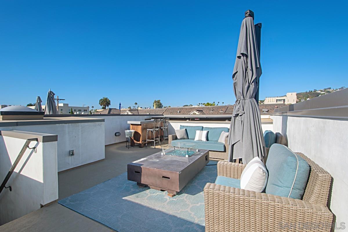712 Silver Street La Jolla, CA 92037 - Photo 13 of 21 a living room with furniture a flat screen tv and a large window