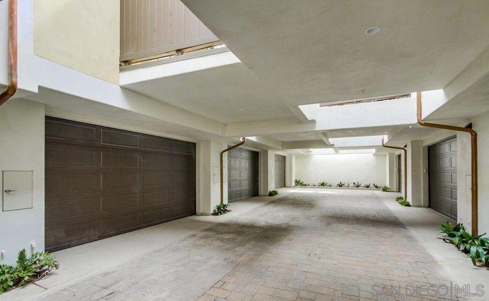 712 Silver Street La Jolla, CA 92037 - Photo 16 of 21 a view of a hallway with a large mirror and a rug