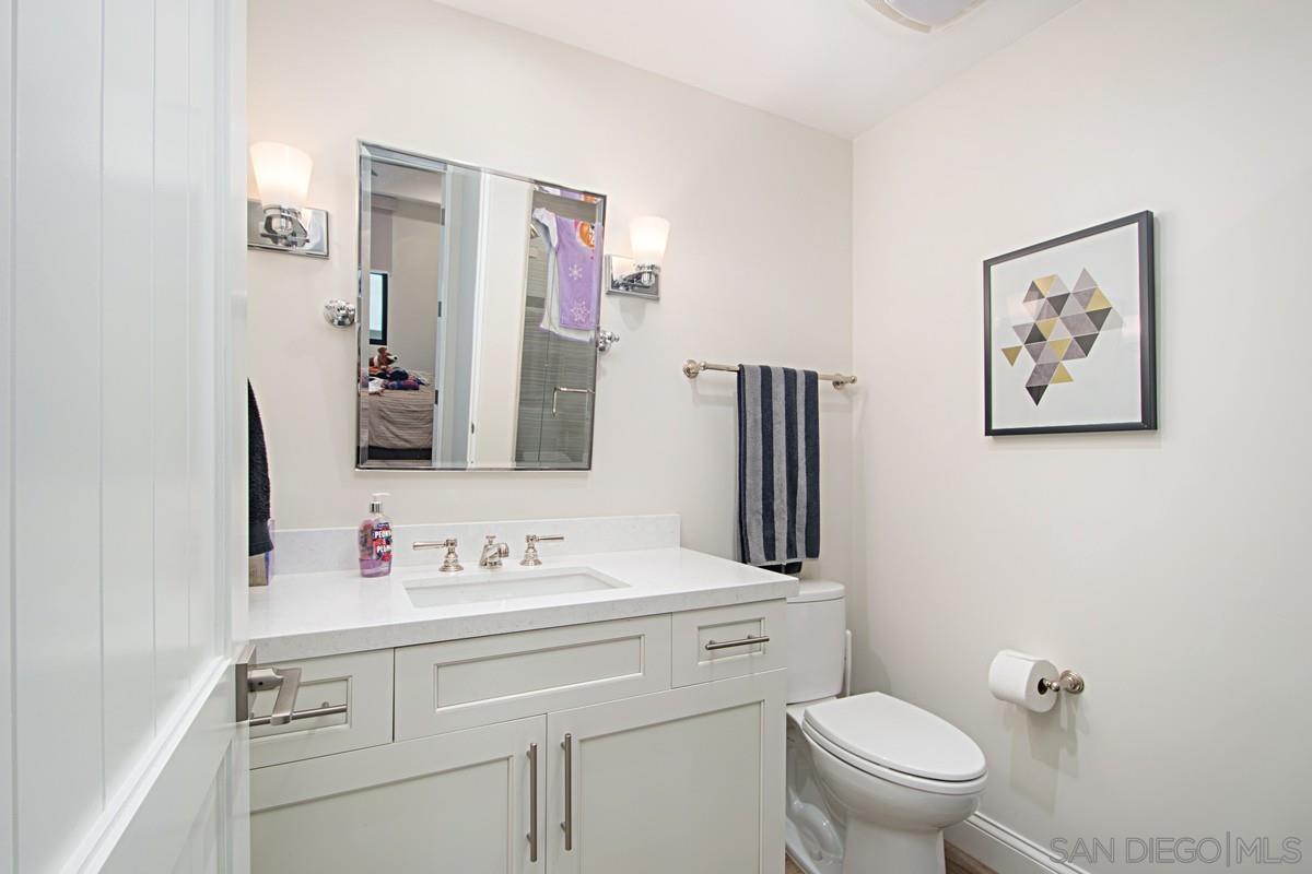 712 Silver Street La Jolla, CA 92037 - Photo 7 of 21 a bathroom with a sink mirror vanity and toilet