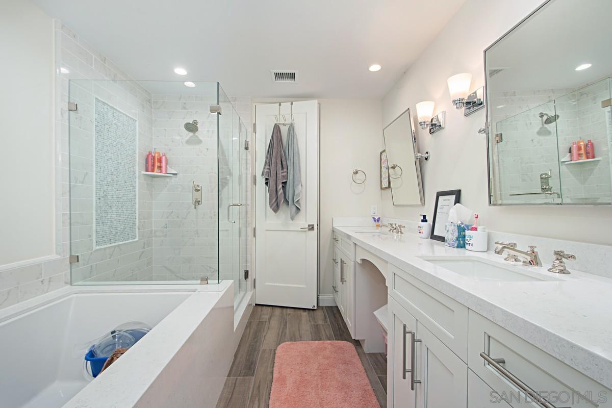 712 Silver Street La Jolla, CA 92037 - Photo 10 of 21 a bathroom with a sink a toilet a tub and shower