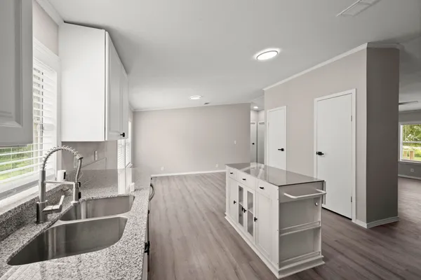 a kitchen with a sink stove and cabinets