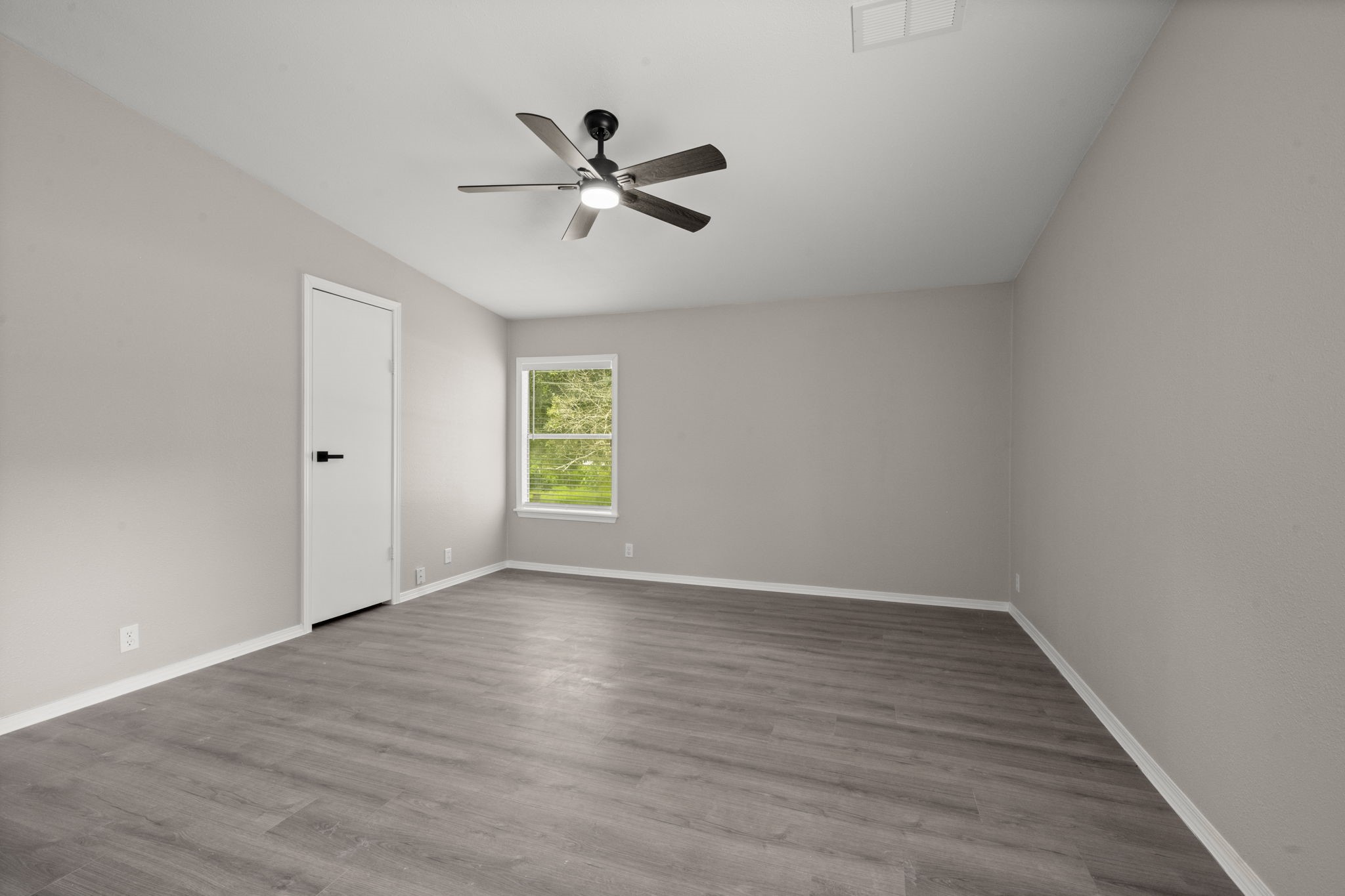 285 County Road 388 Cleveland, TX 77328 - Photo 13 of 23 a view of an empty room with wooden floor and a window