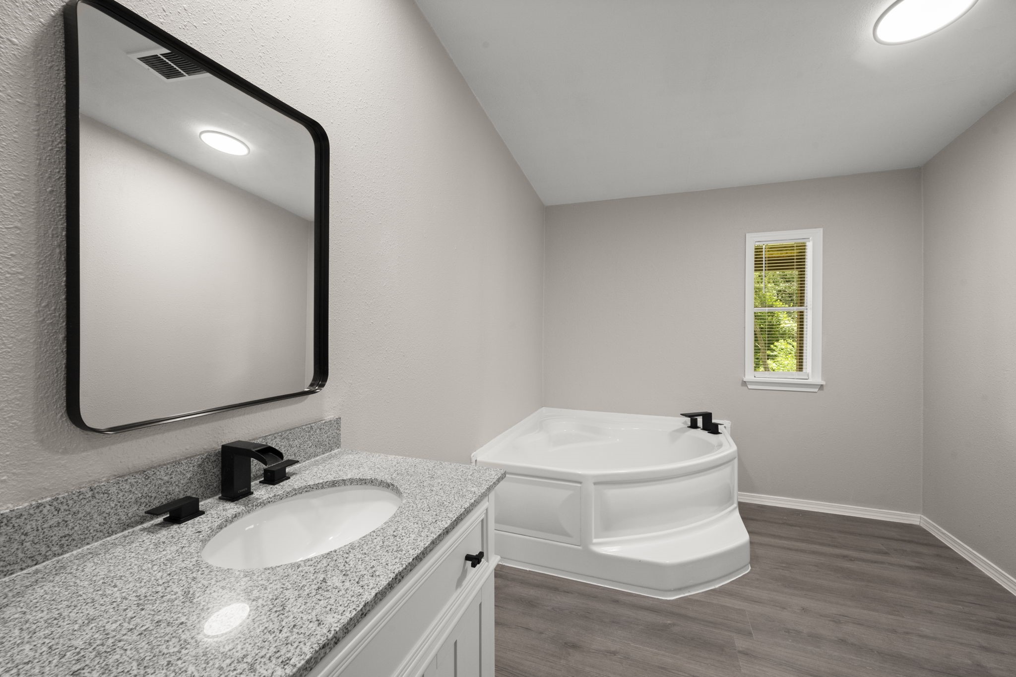 285 County Road 388 Cleveland, TX 77328 - Photo 16 of 23 a bathroom with a granite countertop toilet sink and mirror