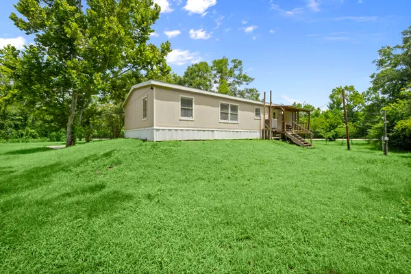 a house with green field in front of it