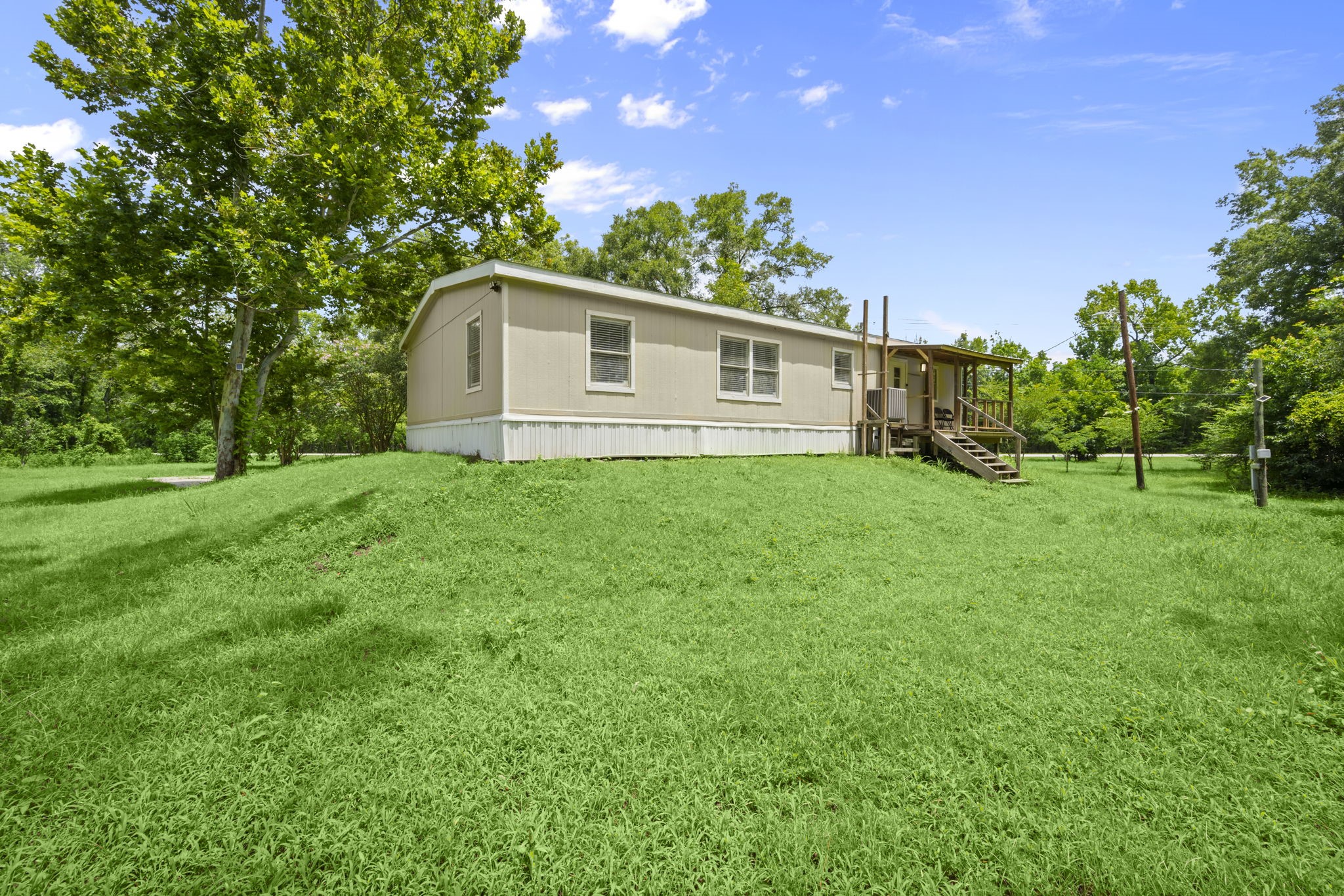 285 County Road 388 Cleveland, TX 77328 - Photo 19 of 23 a house with green field in front of it