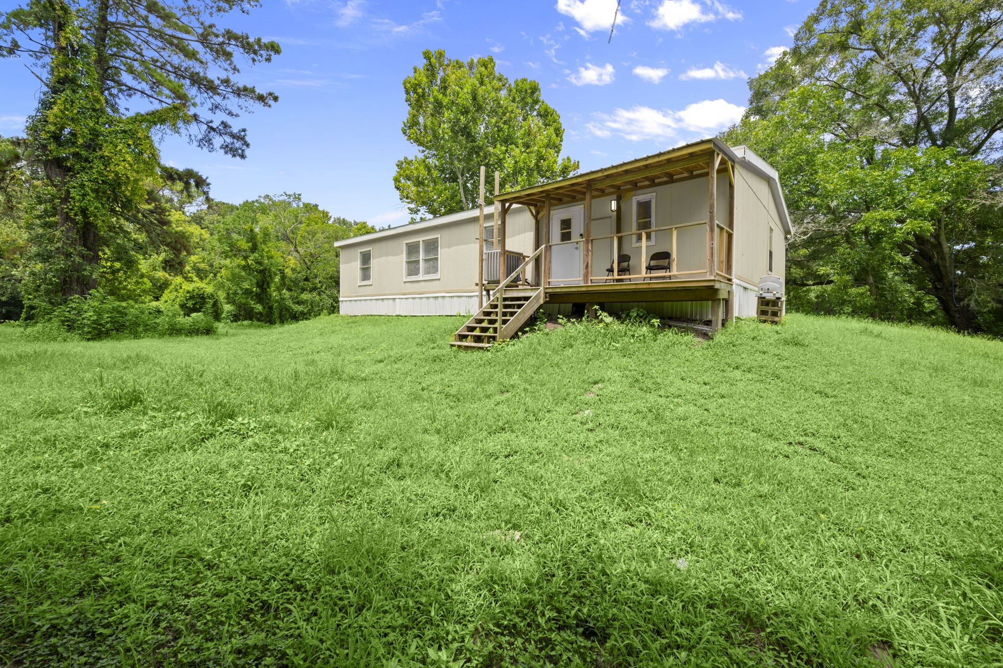285 County Road 388 Cleveland, TX 77328 - Photo 20 of 23 a view of a house with backyard