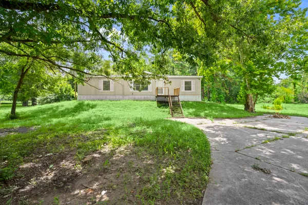 a backyard of a house with table and chairs