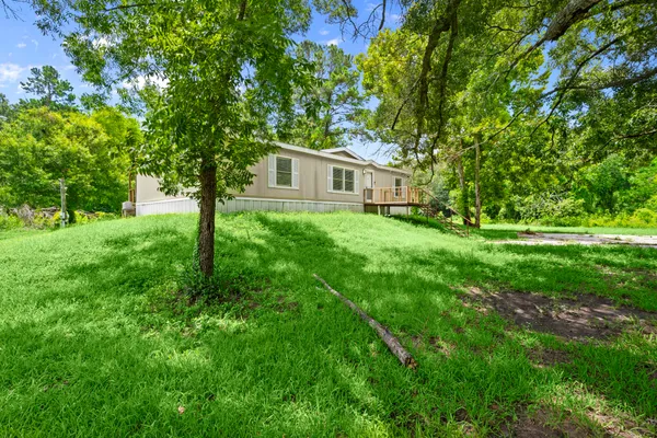a yellow house in middle of the forest