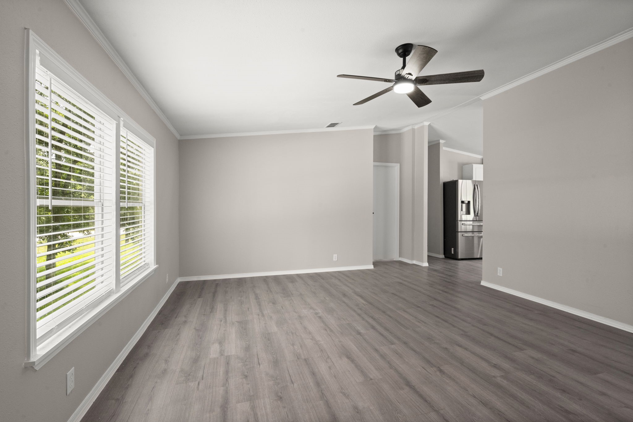 285 County Road 388 Cleveland, TX 77328 - Photo 6 of 23 a view of empty room with wooden floor and ceiling fan