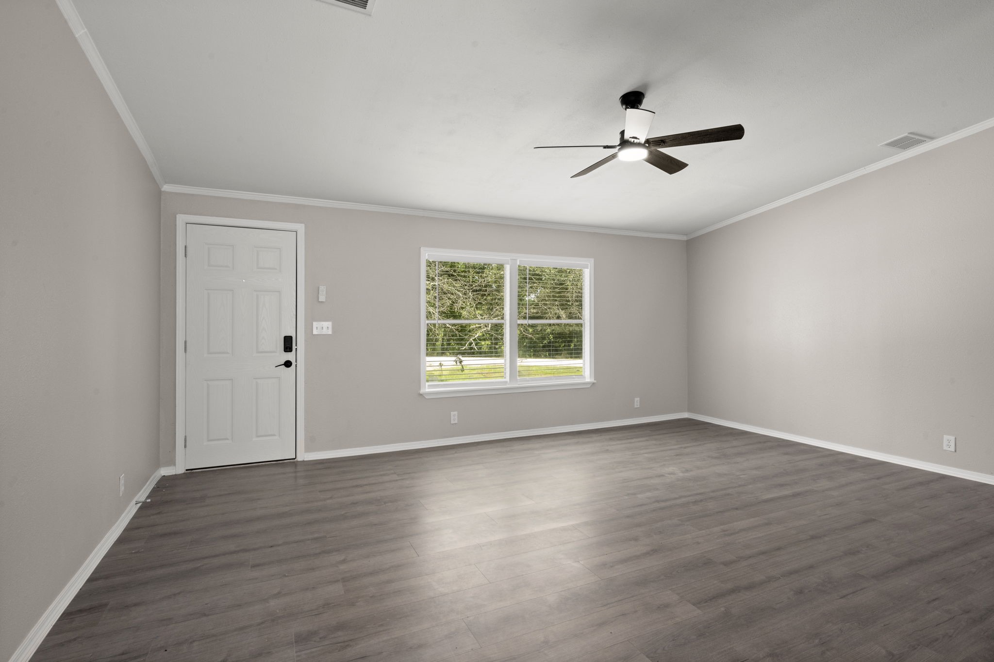 285 County Road 388 Cleveland, TX 77328 - Photo 7 of 23 a view of an empty room with wooden floor and a window