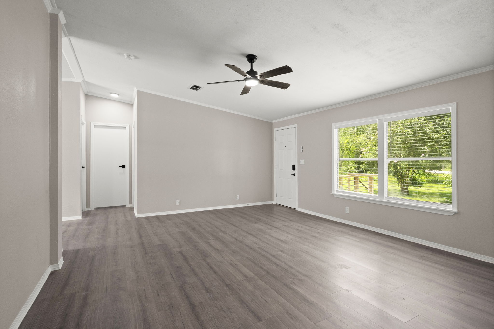 285 County Road 388 Cleveland, TX 77328 - Photo 8 of 23 a view of an empty room with wooden floor and a window