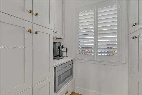 a kitchen with a refrigerator and a window