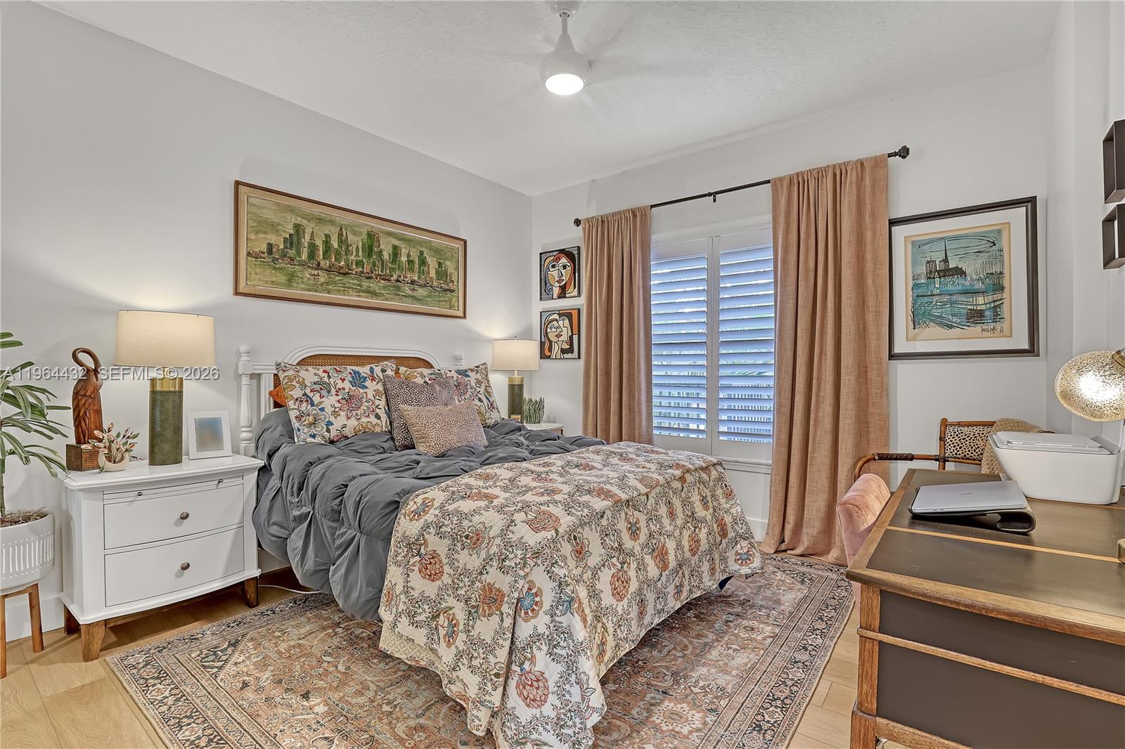 6062 Southeast Landing Way, Unit 10 Stuart, FL 34997 - Photo 13 of 37 a bedroom with a large bed and a window