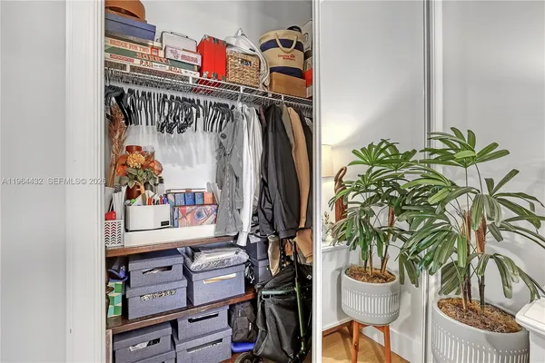 a view of walk in closet with clothes and shoes