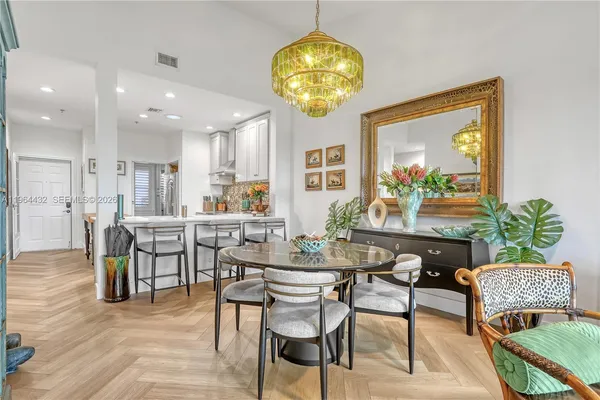 a view of a dining room with furniture and chandelier