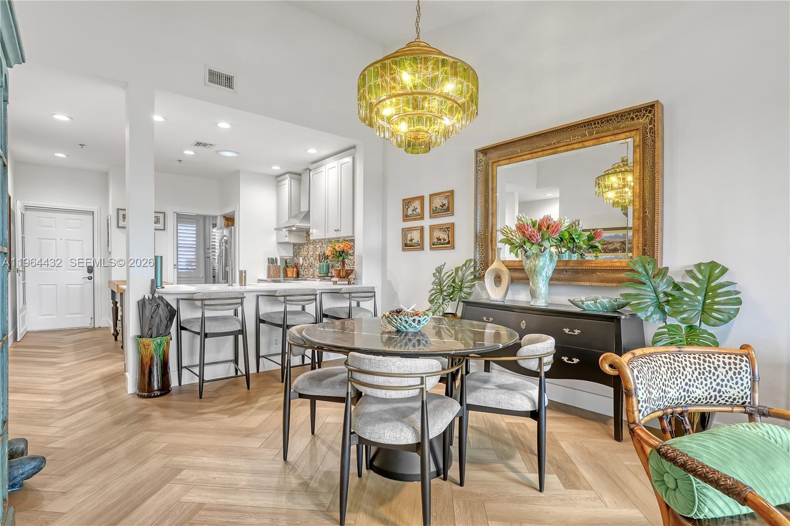 6062 Southeast Landing Way, Unit 10 Stuart, FL 34997 - Photo 18 of 37 a view of a dining room with furniture and chandelier