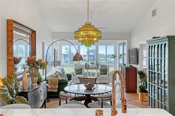 a living room with furniture and a chandelier