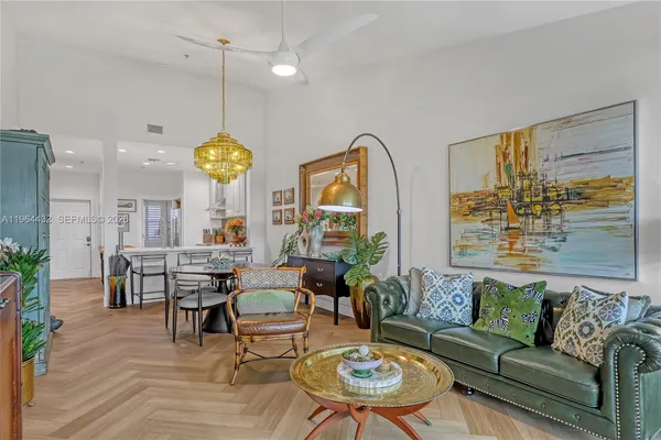 a living room with fireplace furniture and a chandelier