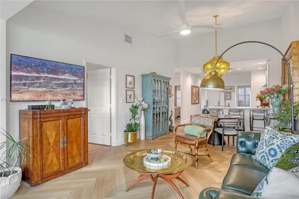 a dining room filled with furniture and wooden floor