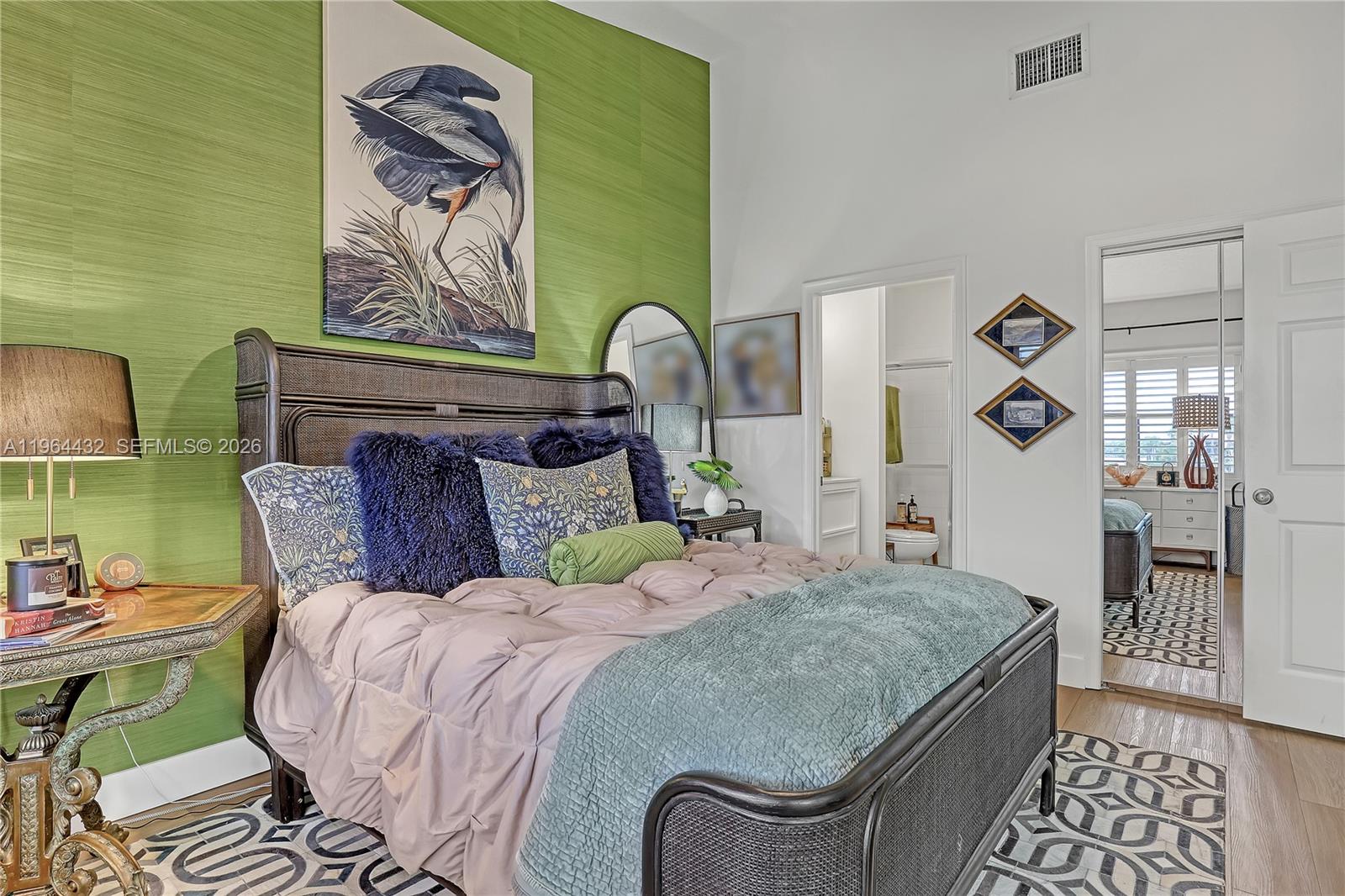 6062 Southeast Landing Way, Unit 10 Stuart, FL 34997 - Photo 27 of 37 a bed sitting in a bedroom next to a window with outer view