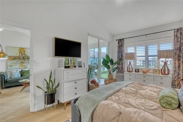 a bedroom with a bed and a flat screen tv