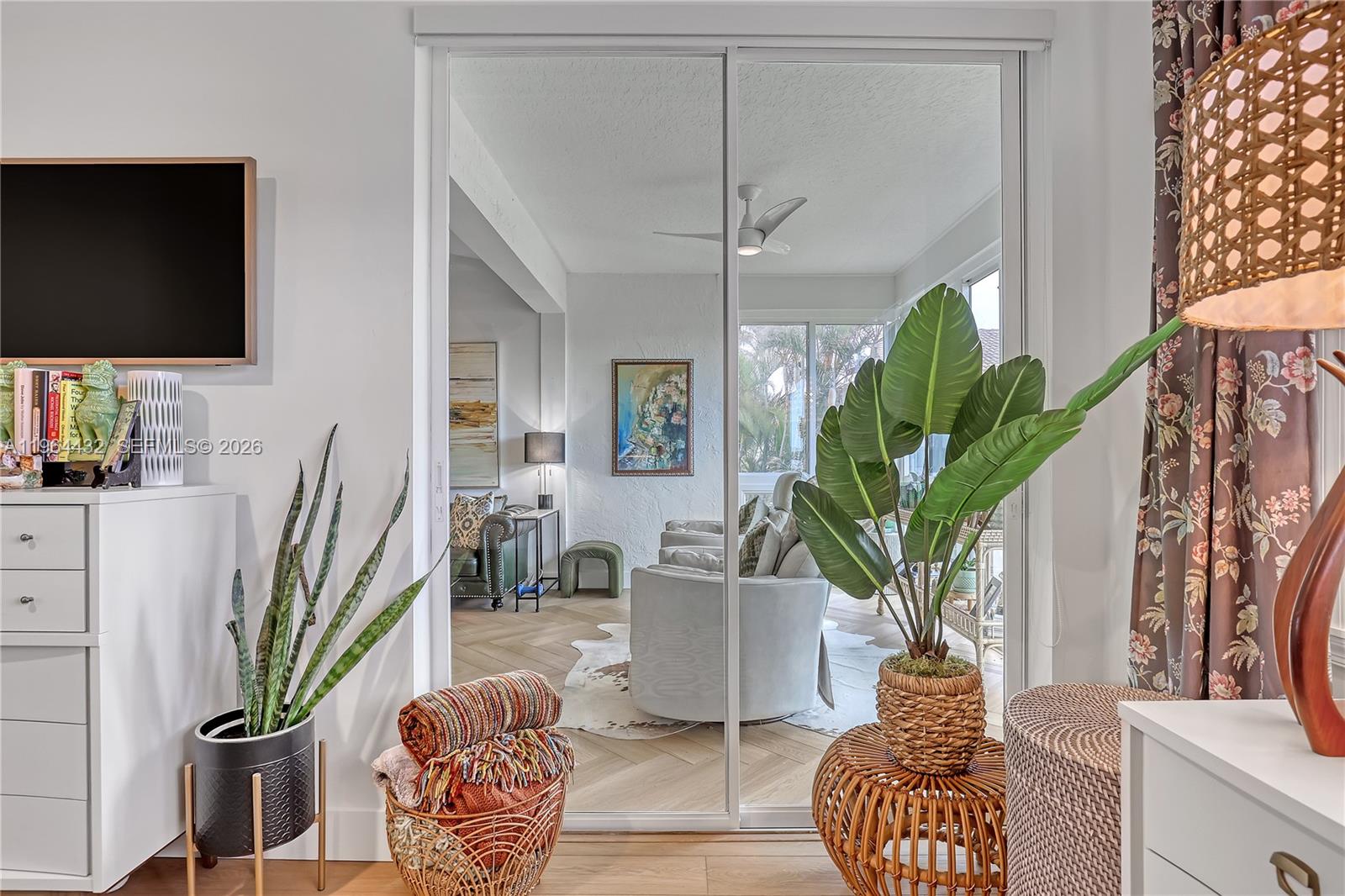 6062 Southeast Landing Way, Unit 10 Stuart, FL 34997 - Photo 30 of 37 a living room with furniture a potted plant and a flat screen tv