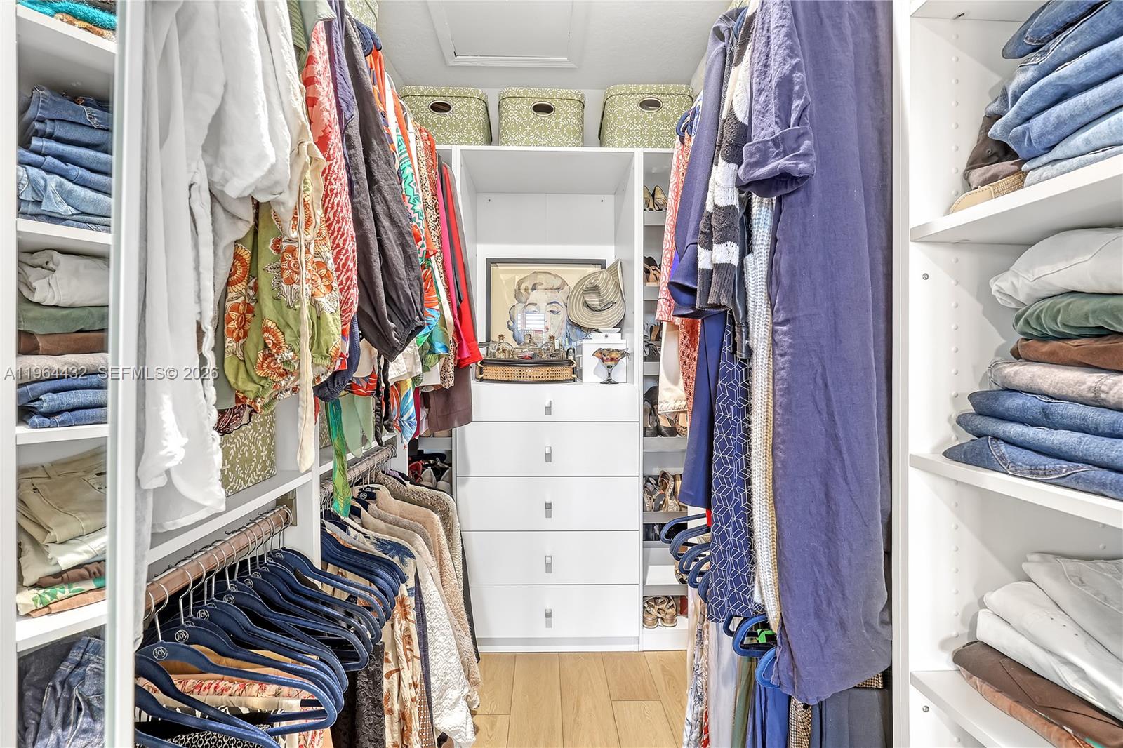 6062 Southeast Landing Way, Unit 10 Stuart, FL 34997 - Photo 31 of 37 a view of walk in closet with clothes and shoes