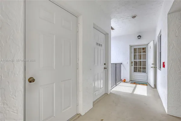 a view of a hallway with wooden shelves