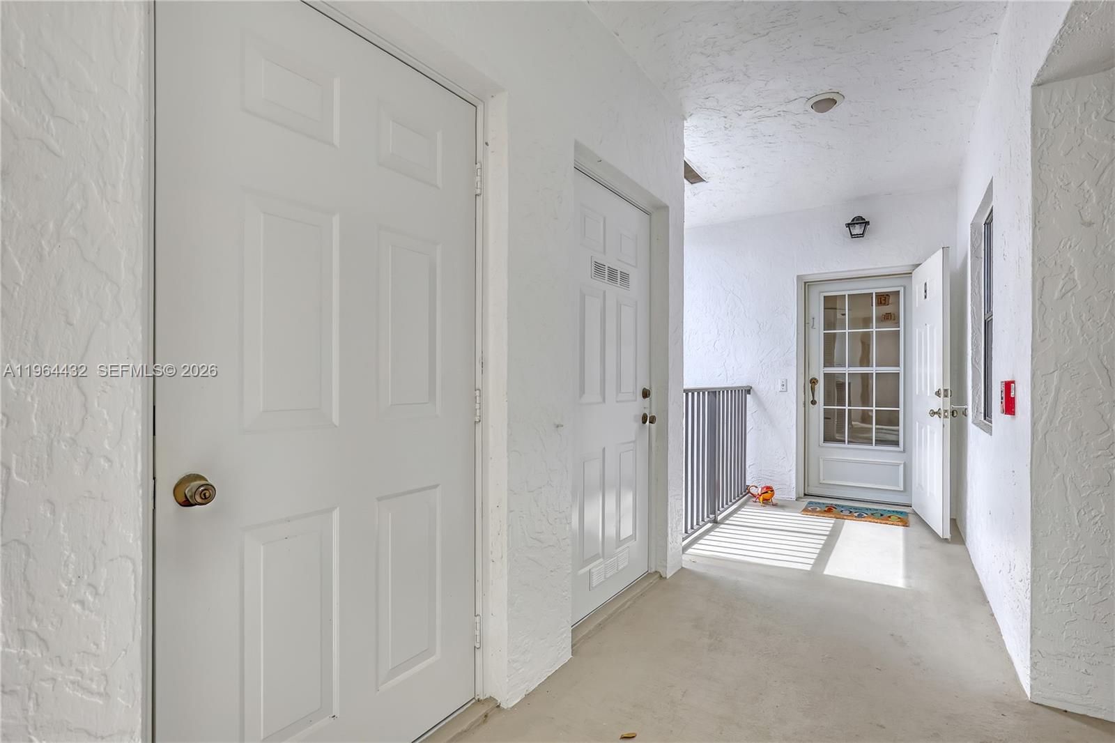 6062 Southeast Landing Way, Unit 10 Stuart, FL 34997 - Photo 4 of 37 a view of a hallway with wooden shelves