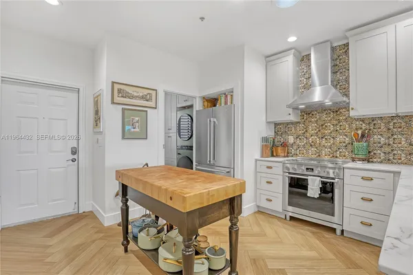 a kitchen with a stove a sink and a refrigerator