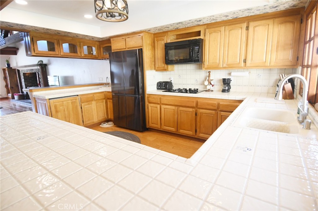 5621 Alwick Place Brea, CA 92821 - Photo 14 of 43 a kitchen with stainless steel appliances kitchen island granite countertop a sink and a stove top oven