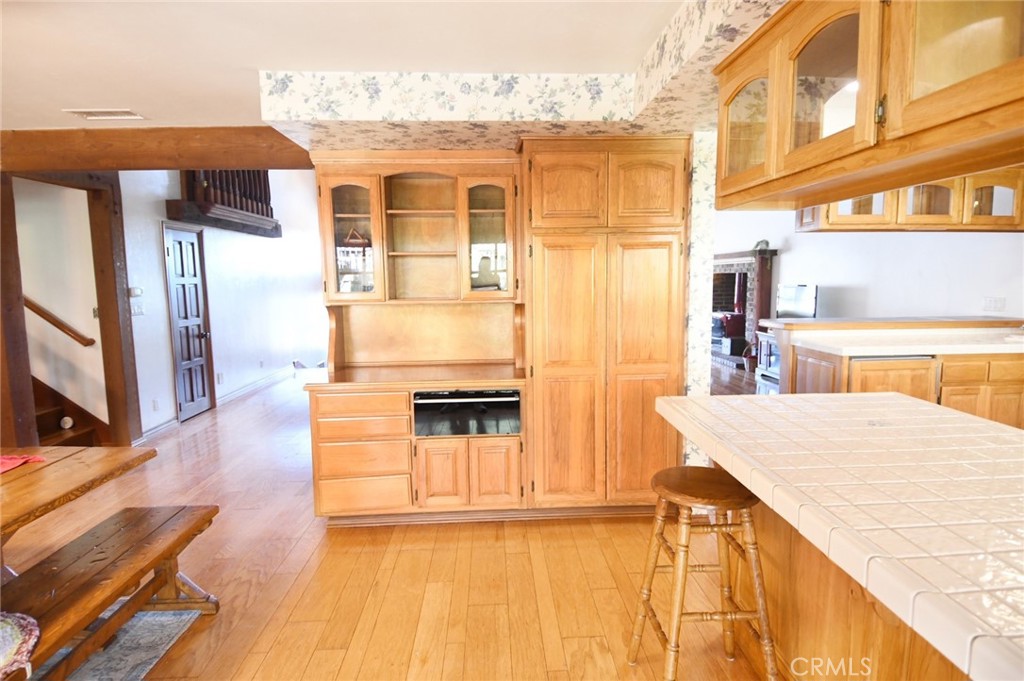 5621 Alwick Place Brea, CA 92821 - Photo 17 of 43 a view of kitchen with granite countertop cabinets and wooden floor